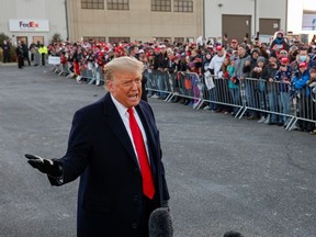U.S. President Donald Trump talks to the media as Trump supporters gather in Rochester, Minnesota, U.S., October 30, 2020.