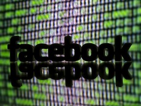 A 3D-printed Facebook logo is seen in front of a displayed cyber code in this illustration taken March 22, 2016.