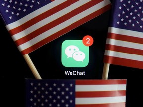 The messenger app WeChat is seen among U.S. flags in this illustration picture taken Aug. 7, 2020.