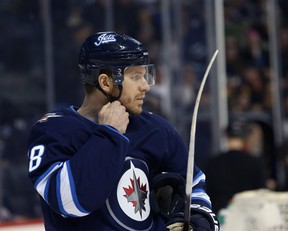 Winnipeg Jets centre Bryan Little straps up his helmet as he readies for his 800th NHL game, against the Vegas Golden Knights in Winnipeg, on Tues., Jan. 15, 2019. Kevin King/Winnipeg Sun/Postmedia Network