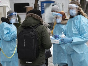 Health care workers organize people waiting in line for COVID-19 testing at the Park Extension COVID-19 clinic on Thursday November 26, 2020.