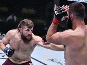 Tanner Boser, left, of Canada punches Andrei Arlovski of Belarus in a heavyweight fight during the UFC Fight Night event at UFC APEX on November 07, 2020 in Las Vegas, Nevada.