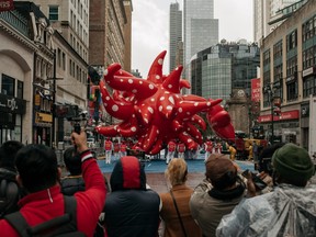 A small crowd gathers at NYPD barricades during the Macy's Thanksgiving Day Parade on Nov. 26, 2020 in New York City.