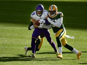 Adam Thielen of the Minnesota Vikings is tackled by Krys Barnes of the Green Bay Packers during the third quarter of the game at Lambeau Field on November 01, 2020 in Green Bay, Wisconsin.