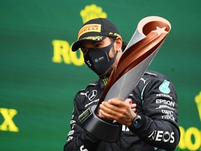 Race winner Lewis Hamilton of Great Britain and Mercedes GP celebrates winning a 7th F1 World Drivers Championship on the podium during the F1 Grand Prix of Turkey at Intercity Istanbul Park on Nov. 15, 2020 in Istanbul, Turkey.