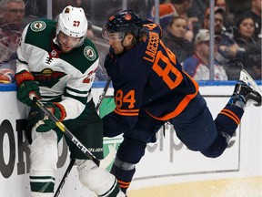 Edmonton Oilers defenceman William Lagesson (84) battles Minnesota Wild's Alex Galchenyuk (27) at Rogers Place on Feb. 21, 2020.