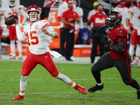 Chiefs quarterback Patrick Mahomes (left) makes a pass as Buccaneers defensive end William Gholston closes in during the first half in Tampa yesterday. Mahomes threw for 462 yards and three TDs in the 27-24 win over the Chiefs.