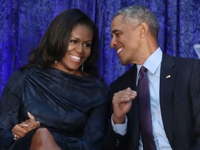 Former U.S. President Barack Obama and first lady Michelle Obama participate in the unveiling of their official portraits during a ceremony at the Smithsonian's National Portrait Gallery, on February 12, 2018 in Washington, DC.