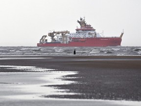 Polar research ship, the RRS Sir David Attenborough, sails out of the River Mersey past Antony Gormley's art installation 'Another Place' at Crosby, north west England on Nov. 3, 2020.