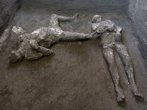 This undated photo handout on Nov. 21, 2020 by the Pompeii Archaeological Park shows casts of the bodies of two men, a 40-year-old master and his young slave, after they were found during recent excavations of a Villa in Civita Giuliana in the outskirts of Pompeii.