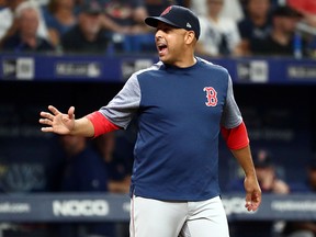 Boston Red Sox manager Alex Cora (20) reacts during a game against the Tampa Bay Rays at Tropicana Field.