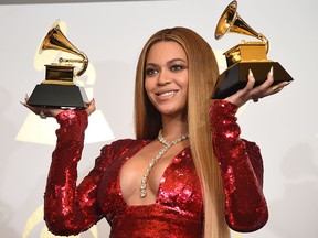 In this file photo singer Beyonce poses with her Grammy trophies in the press room during the 59th Annual Grammy music Awards in Los Angeles.