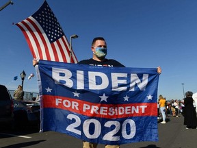 A supporter of former vice-president and President elect Joe Biden celebrates his victory in Wilmington, Delaware, Saturday, Nov. 7, 2020.