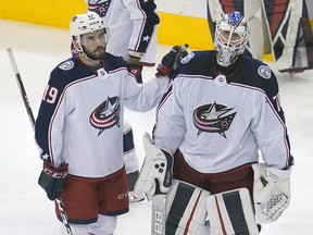 Columbus Blue Jackets centre Liam Foudy (19) and goaltender Joonas Korpisalo (70) react following their loss to the Tampa Bay Lightning at Scotiabank Arena.