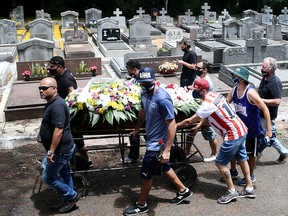 Relatives and friends attend the burial of Joao Alberto Silveira Freitas, who was beaten to death by security guards at a Carrefour supermarket in Porto Alegre, Brazil, November 21, 2020.