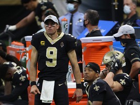 Drew Brees (9) and Jameis Winston (2) of the New Orleans Saints look on from the sideline during their game against the San Francisco 49ers at Mercedes-Benz Superdome on November 15, 2020 in New Orleans.