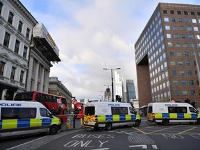 In this file photo taken on Dec. 1, 2019, police vans block the south side entrance to London Bridge in the City of London, following the Nov. 29 deadly terror incident.