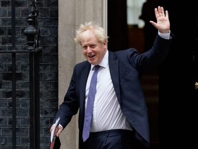 In this file photo taken Sept. 8, 2020, Britain's Prime Minister Boris Johnson waves as he leaves 10 Downing Street in London.