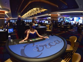 A casino dealer waits at her blackjack table prior to the official opening of the Circa Resort & Casino during a grand opening event in Las Vegas October 27, 2020.