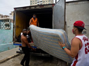 Cubans move their belongings to safe places due to possible floods from Tropical Storm Eta in Havana, on November 8, 2020. - Tropical storm Eta brought strong winds and torrential rain to Cuba on Sunday after having earlier cut a destructive and deadly path through parts of Central America and southern Mexico. (Photo by YAMIL LAGE / AFP) (Photo by YAMIL LAGE/AFP via Getty Images)