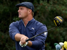 Bryson DeChambeau plays his shot from the 18th tee during the continuation of the second round of the Masters at Augusta National Golf Club on November 14, 2020 in Augusta, Georgia.