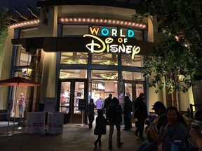 People visit Disneyland, where parts of the park opened for more retail and dining as an extension of the Downtown Disney District in Anaheim, California on November 19, 2020.