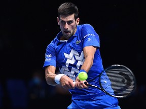 Serbia's Novak Djokovic returns to Russia's Daniil Medvedev during their round-robin match at the ATP World Tour Finals at the O2 Arena in London on November 18, 2020.