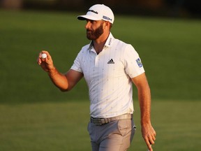 Dustin Johnson reacts after making a par putt on the 18th green during the third round of the Masters at Augusta National in Augusta, Ga., Saturday, Nov. 14, 2020. Johnson heads into the final round with a four-stroke lead.