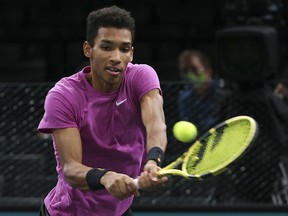 Felix Auger-Aliassime hits a return during the Rolex Paris Masters on November 8, 2020 in Paris.