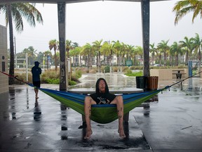 Jamie Chase of Jackson, Michigan, sits in his hammock under the shelter house at Siesta Key Beach before the arrival of Tropical Storm Eta in Siesta Key, Florida, November 11, 2020.