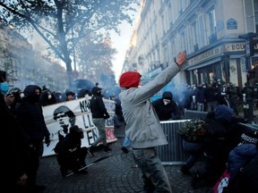 People take part in a demonstration against the "Global Security Bill' that rights groups say would make it a crime to circulate an image of a police officer's face and would infringe journalists' freedom in France, in Paris, November 28, 2020.
