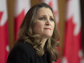 Deputy Prime Minister and Minister of Finance Chrystia Freeland listens to a question from a reporter on the phone during a news conference in Ottawa, Monday, Nov. 30, 2020.