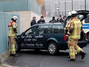 Firefighters remove the car which crashed into the gate of the main entrance of the chancellery in Berlin, the office of German Chancellor Angela Merkel in Berlin, Germany, November 25, 2020.