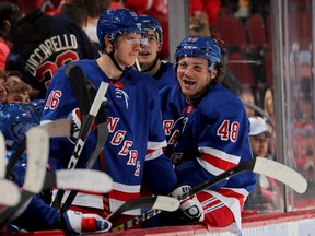 Ryan Strome, left, and Brendan Lemieux of the New York Rangers smile from the bench in the final minutes of the game against the New Jersey Devils at Prudential Center on Nov. 30, 2019 in Newark, N.J.