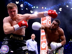 Michael Hunter, right, punches Alexander Povetkin during the of the WBC World Heavyweight Elimnator fight between during the Matchroom Boxing 'Clash on the Dunes' show at the Diriyah Season on Dec. 7, 2019 in Diriyah, Saudi Arabia.