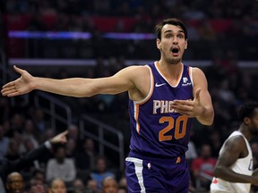 Dario Saric of the Phoenix Suns argues for possession in front of Patrick Beverley of the LA Clippers during the first half at Staples Center on December 17, 2019 in Los Angeles, California.