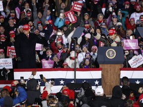 Rapper Lil Pump, right, speaks next to U.S. President Donald Trump during a rally on Nov. 3, 2020 in Grand Rapids, Michigan.