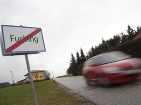 A car drives by a road sign that reads the name of the Austrian village "Fucking" in western Austria on a cloudy day on Jan. 7, 2013.