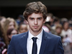 British actor Freddie Highmore poses for photographers as he arrives for the 2015 Empire Awards in central London on March 29, 2015.