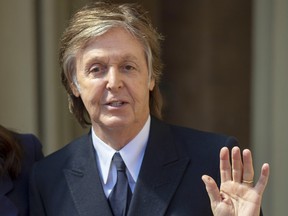Paul McCartney waves following an Investiture ceremony, where he was made a Companion of Honour at Buckingham Palace on May 4, 2018 in London.