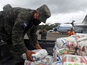Honduran Air Force members load supplies on planes, to be taken to residents of Puerto Lempira municipality in preparation for the arrival of Hurricane Eta on November 2, 2020.