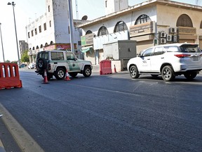 Saudi police close a street leading to a non-Muslim cemetery in the Saudi city of Jeddah where a bomb struck a World War I commemoration attended by European diplomats on November 11, 2020.
