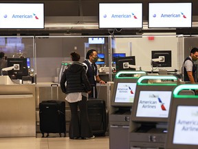 A woman checks in for her flight at LaGuardia Airport on November 25, 2020 in New York.