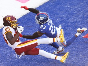 Cam Sims of the Washington Football Team catches a touchdown pass against Logan Ryan of the New York Giants at MetLife Stadium on October 18, 2020 in East Rutherford, N.J.
