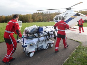A patient infected with the coronavirus (COVID-19) is transported to a medical helicopter to be transferred from the CHU de Liege hospital to Germany in Liege, Belgium November 3, 2020,