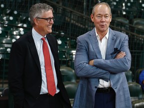 Houston Astros owner Jim Crane, right, and general manager Jeff Luhnow chat during batting practice at Minute Maid Park on June 30, 2017 in Houston.
