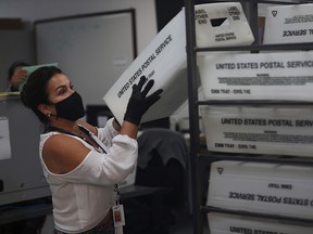 A worker at the Miami-Dade County Elections Department works on tabulating the Vote by Mail ballots that have been returned on November 3, 2020 in Doral, Florida