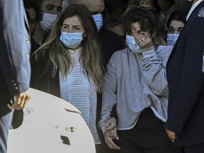 The daughters of Diego Maradona, Dalma (left) and Giannina, leave the Casa Rosada presidential palace at the end of the wake in Buenos Aires on November 26, 2020.