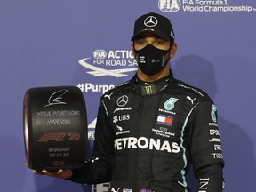 Formula One F1 - Bahrain Grand Prix - Bahrain International Circuit, Sakhir, Bahrain - November 28, 2020 Mercedes' Lewis Hamilton celebrates with an award after qualifying in pole position.