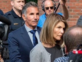 In this file photo taken Aug. 27, 2019, actress Lori Loughlin and husband Mossimo Giannulli exit the Boston Federal Court house after a pre-trial hearing.